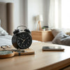 Bluetooth-enabled alarm clock on a bedside table with a smartphone nearby for seamless pairing