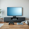 Modern living room with a large smart TV, streaming glow, and a game controller on a coffee table