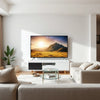 65-inch flat-screen TV in a modern living room, showing a crisp 4K scene with subtle comparison cues