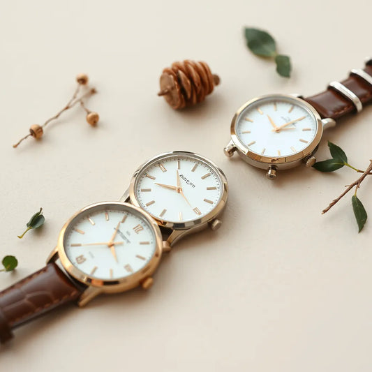Assorted elegant women’s wrist watches with leather and metal straps on a neutral background