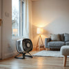 Compact electric PTC fan heater providing warm airflow in a bright, modern living room