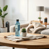 Modern living room with minimalist lifestyle items, cozy textiles, and a sleek smart home device
