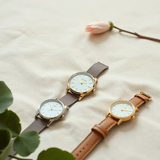 Assorted women’s wristwatches displayed neatly on a neutral background in soft daylight