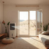 Desert air cooler by an open window with visible airflow mist in a bright living room