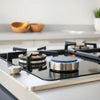 Auto-ignition gas hob with control knobs and cooktop burners in a clean modern kitchen