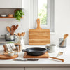 Neatly arranged kitchen tools and cookware on a clean countertop with natural light
