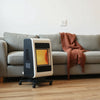 Modern electric room heater warming a living room with a couch and wall thermostat nearby