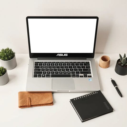 ASUS Vivobook laptop on a clean desk with a notebook and pen in natural light