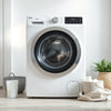 Modern fully automatic washing machine in a clean, softly lit laundry room