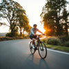 Cyclist riding smoothly on a paved road with relaxed posture and well-fitted gear