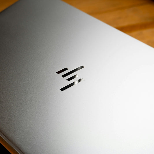 A close up of a laptop on a wooden table
