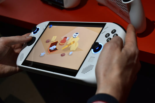 Person playing a handheld gaming device with colorful screen