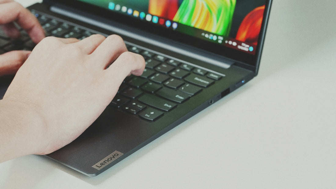 Person typing on a laptop keyboard