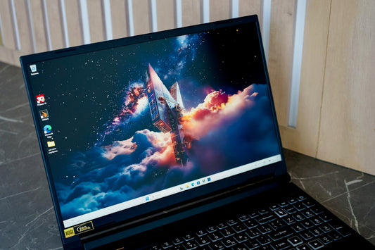 A black laptop displaying a space rocket wallpaper.
