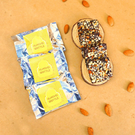 Oriole Gifts Rakhi Hamper for Brother with Premium Evil Eye Rakhi, Chocolate Bites, Almond Brittles, Coffee Almond Nutties, Paan Shots, Snacks & Greeting Card | Rakshabandhan Gift for Brother with Chocolate Gift Box 