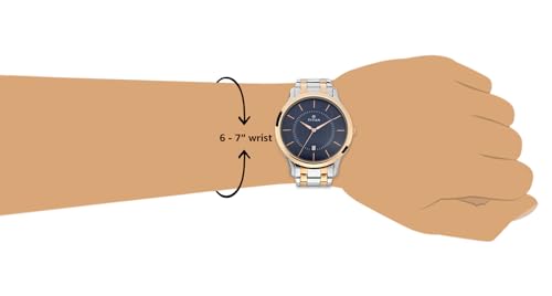 Titan Karishma analog blue dial watch on rose-gold stainless steel band, worn on a 6-7 inch wrist.